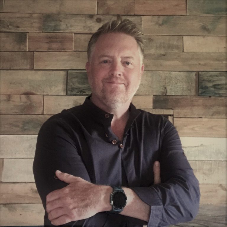 An atmospheric oil painting of Dartmoor with a storm passing over Vixen Tor in the evening light by renowned Dartmoor artist Tim Yorke-Dunne